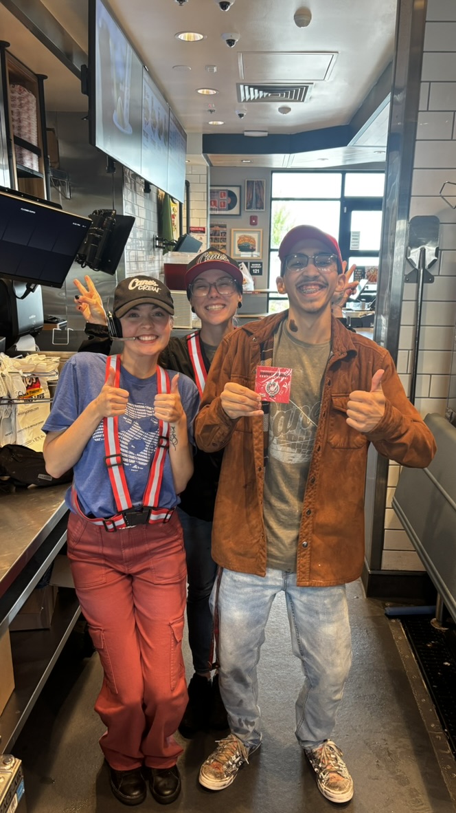 Josiah smiling with his Raising Cane’s teammates